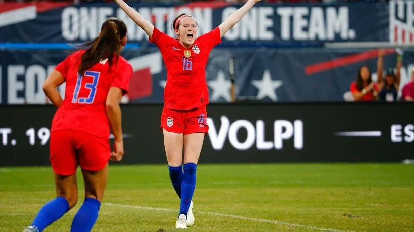 US women’s national soccer team celebrating beside Volpi sponsorship signage